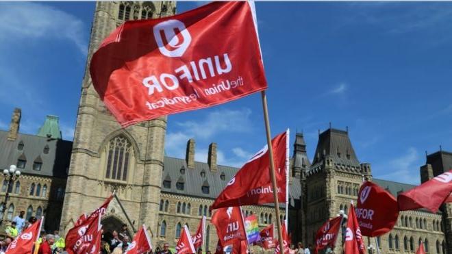 十博官网在线 flags fly in front of the Peace Tower on Parliment Hill in Ottawa.